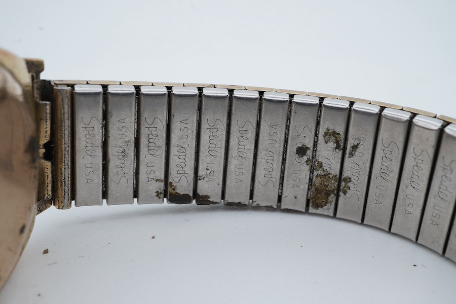 A 1930's 9ct gold Rolex manual wind wrist watch, with Arabic dial and subsidiary seconds, retailed by Grant & Son, Carlisle, on an associated gold plated flexible strap, case diameter 28mm (hand loose in dial). Condition